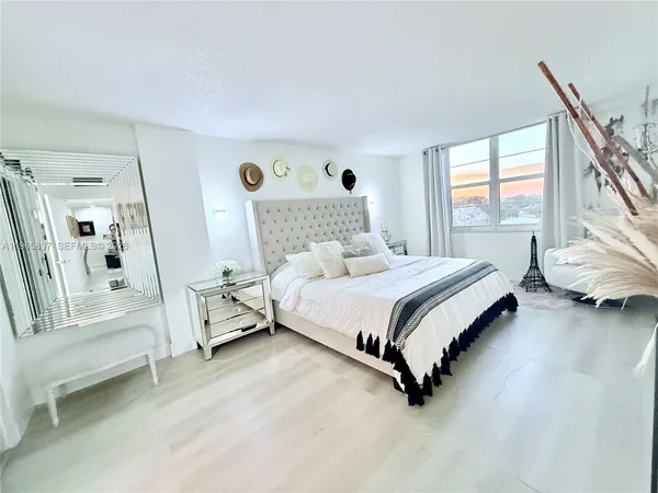 a bedroom with a bed and a large window