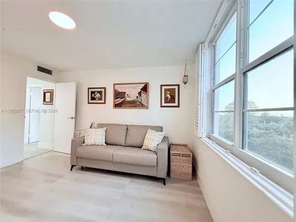 a living room with furniture and a large window