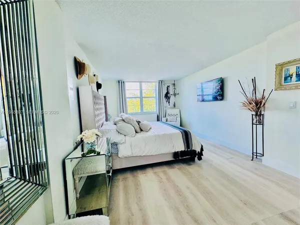 a spacious bedroom with a bed and a couch