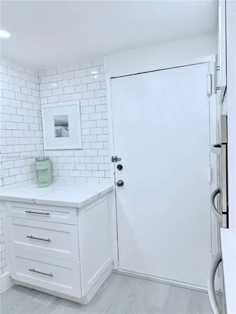 a bathroom with a shower and a sink