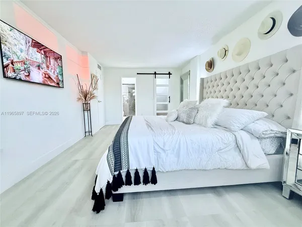 a bedroom with a bed and window