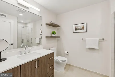 a bathroom with a sink a toilet and a mirror