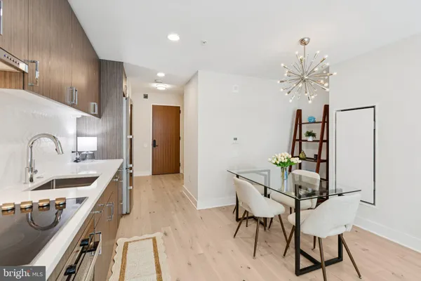 a kitchen that has a sink and chairs