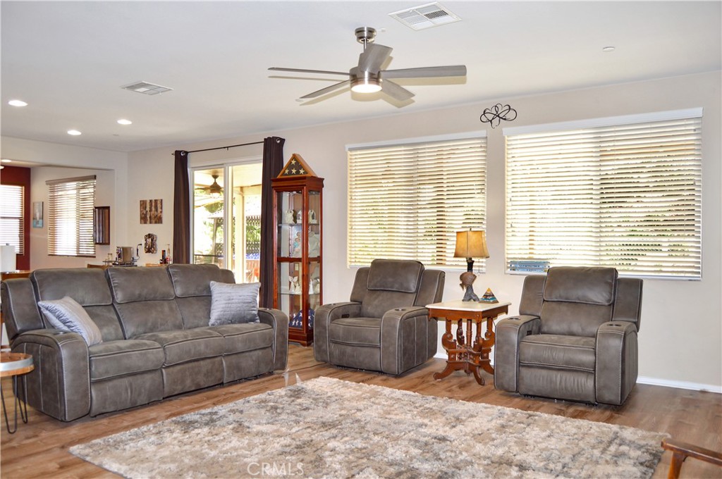 166 Fox Lane Calimesa, CA 92320 - Photo 15 of 76 Spacious Great-Room-Style Living Room with Fabulous Flooring, Ceiling Fan, and Backyard Views