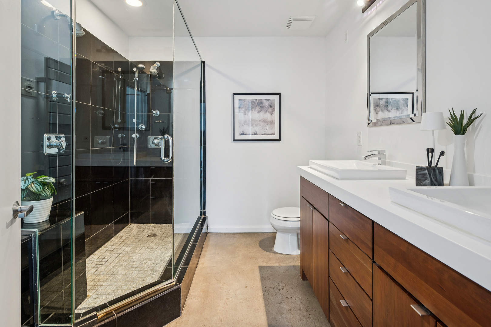 3631 North Halsted Street, Unit 308 Chicago, IL 60613 - Photo 14 of 20 a bathroom with a double vanity sink toilet and shower