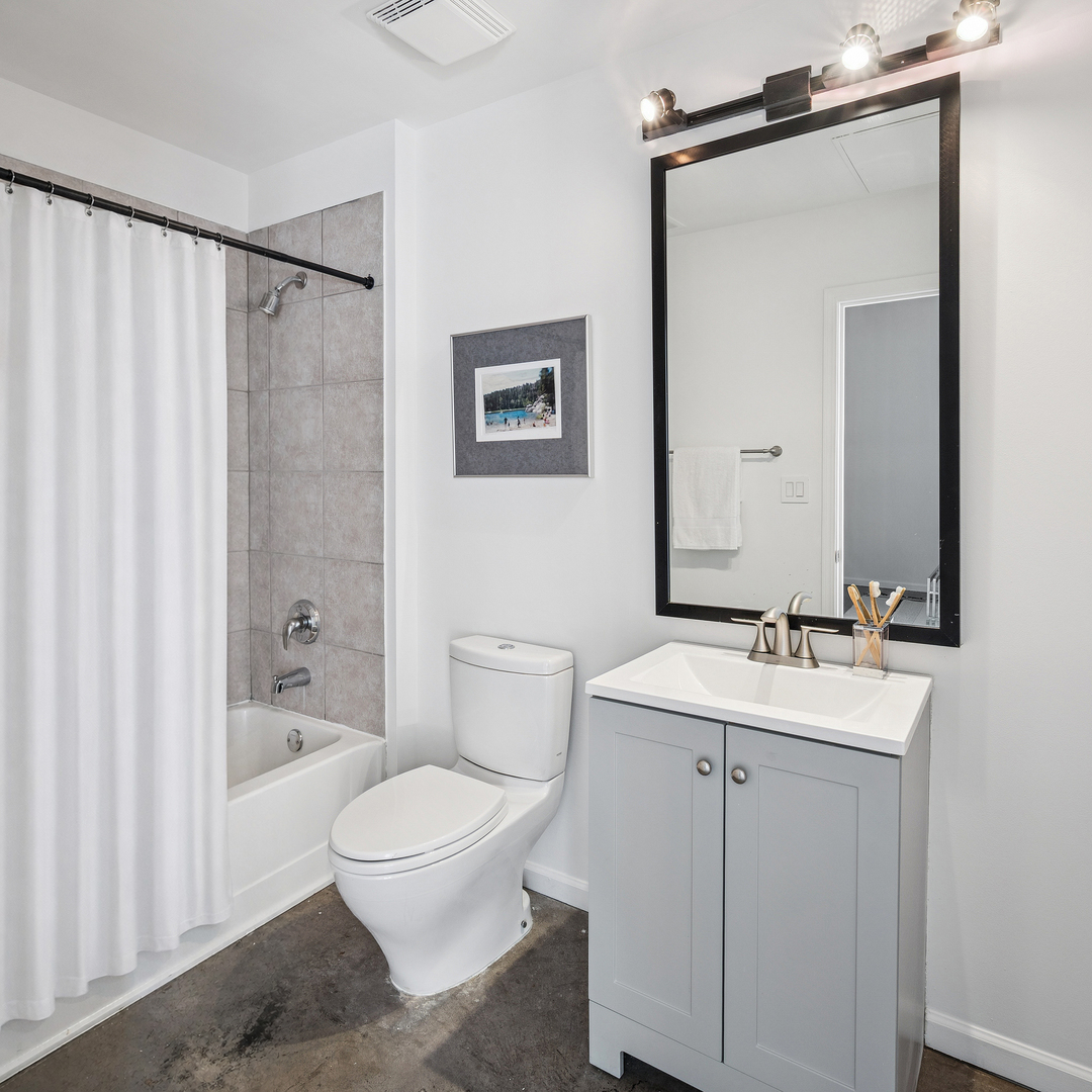3631 North Halsted Street, Unit 308 Chicago, IL 60613 - Photo 16 of 20 a bathroom with a sink a toilet and shower