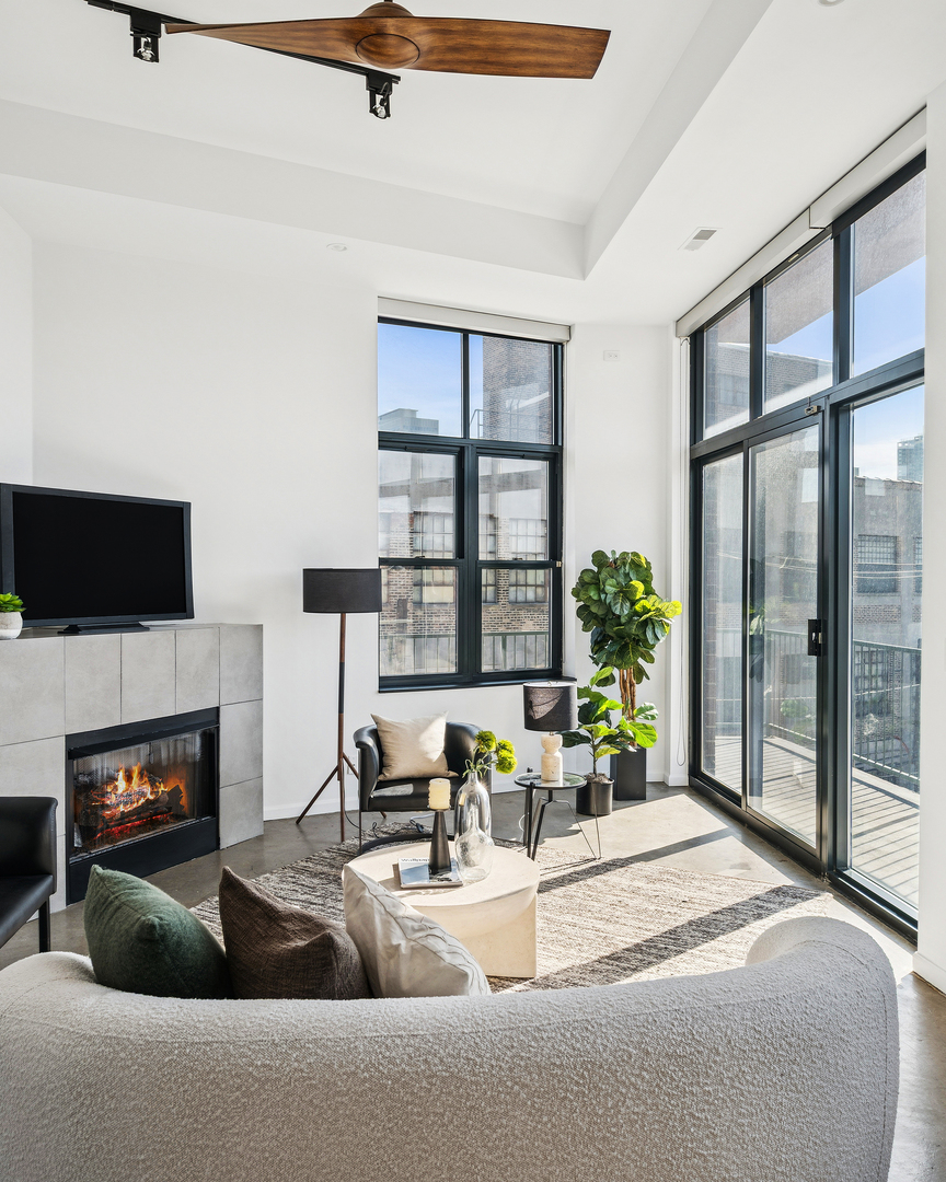 3631 North Halsted Street, Unit 308 Chicago, IL 60613 - Photo 6 of 20 a living room with furniture a fireplace and a flat screen tv