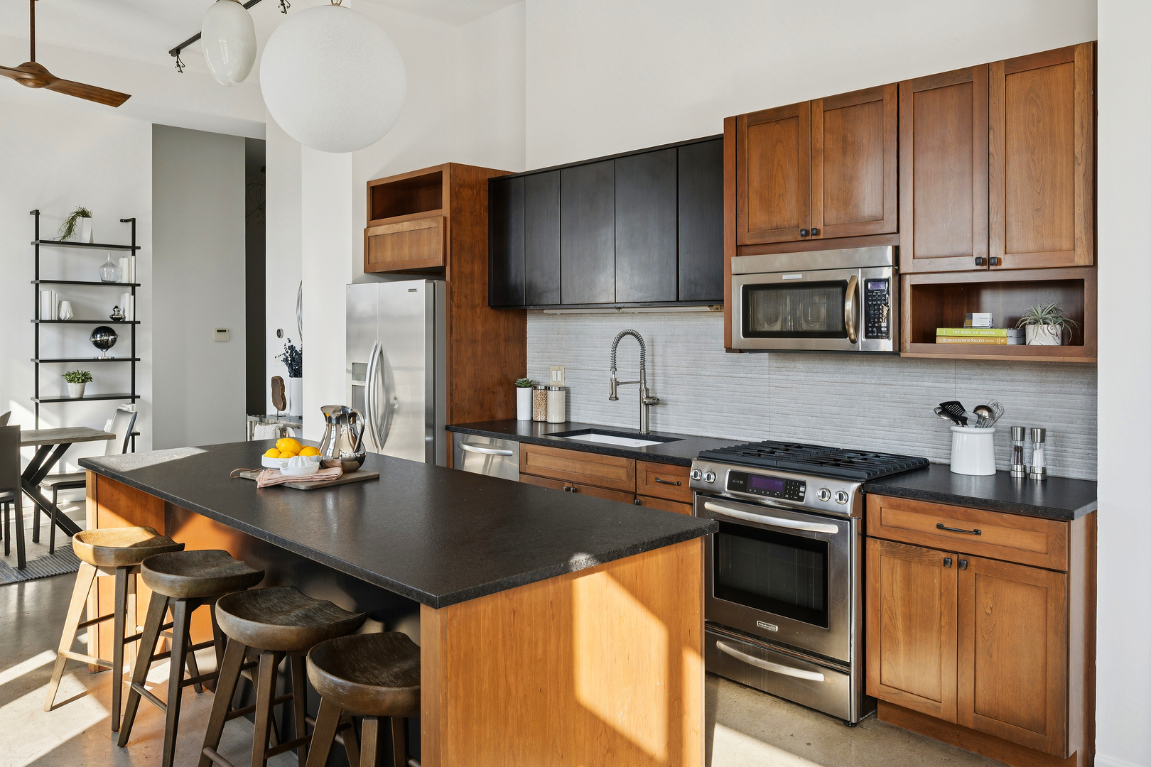3631 North Halsted Street, Unit 308 Chicago, IL 60613 - Photo 8 of 20 a kitchen with stainless steel appliances granite countertop a stove a sink dishwasher and cabinets with wooden floor