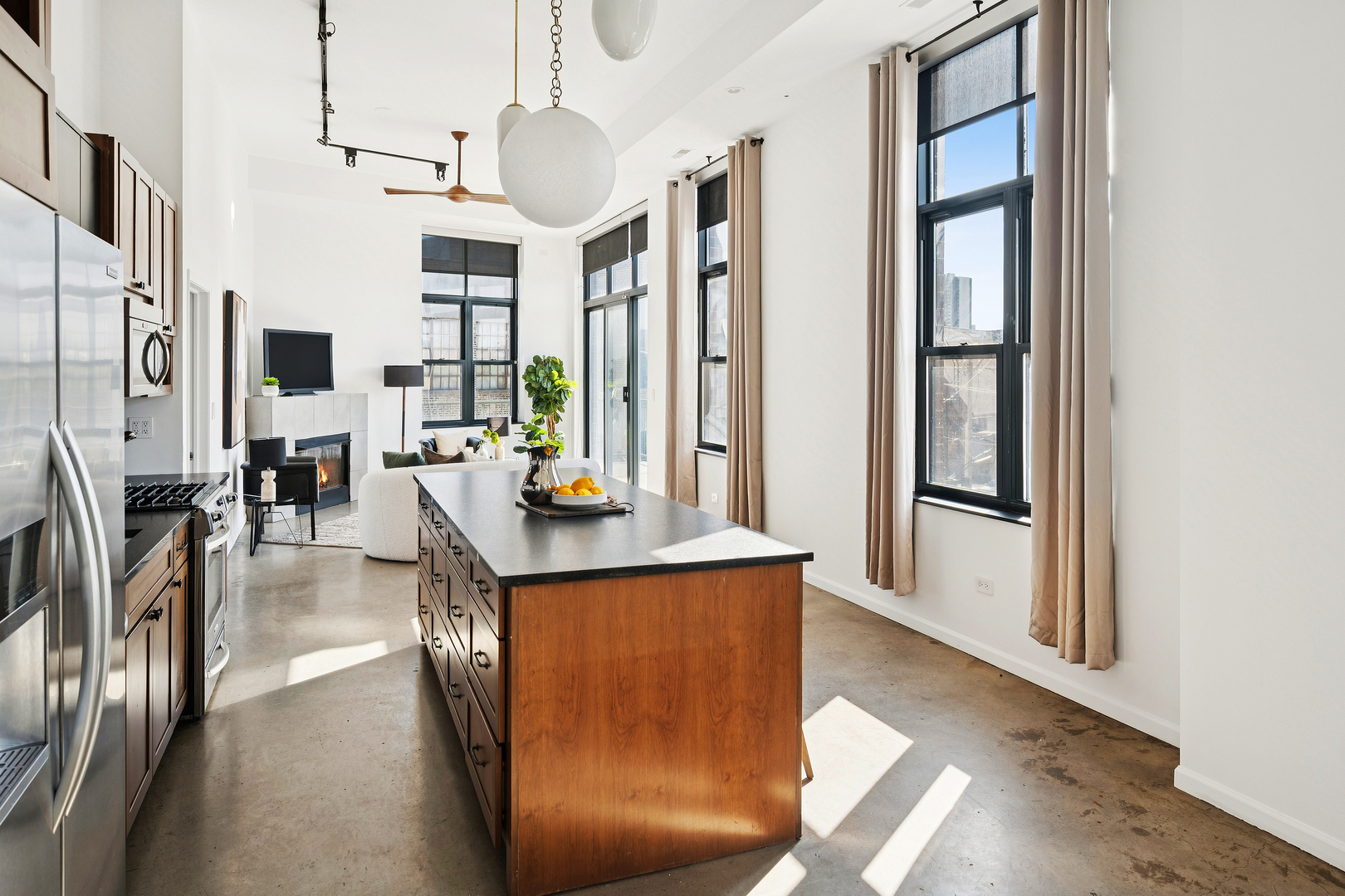 3631 North Halsted Street, Unit 308 Chicago, IL 60613 - Photo 9 of 20 a living room with stainless steel appliances furniture a large window and a wooden floor