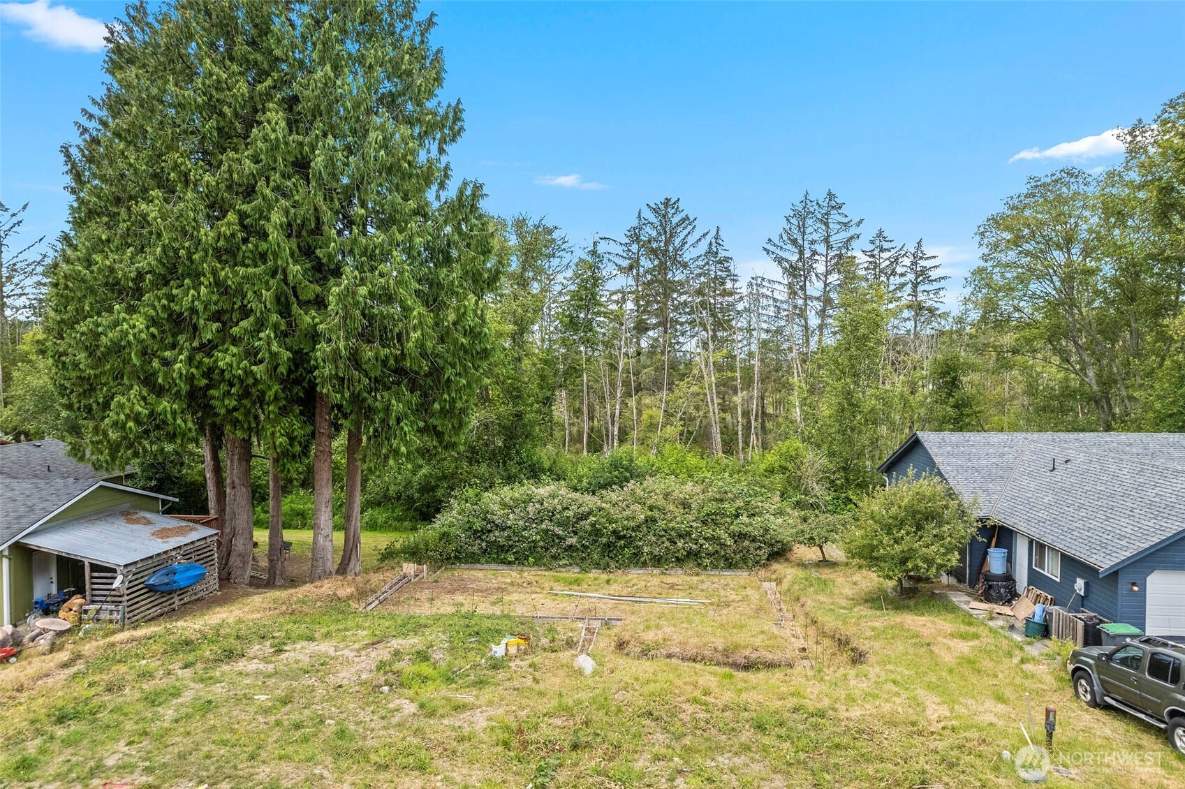 5002 Deception Circle Oak Harbor, WA 98277 - Photo 2 of 8 a view of a house with a yard and covered with trees