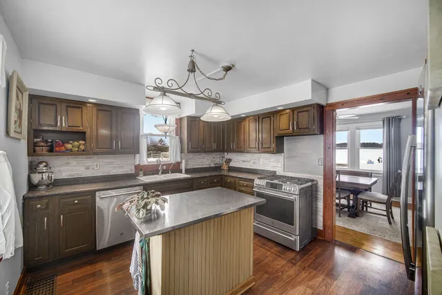 a kitchen with stainless steel appliances granite countertop a stove and a sink