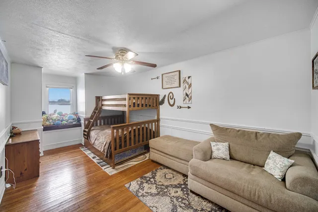 a bedroom with furniture and wooden floor