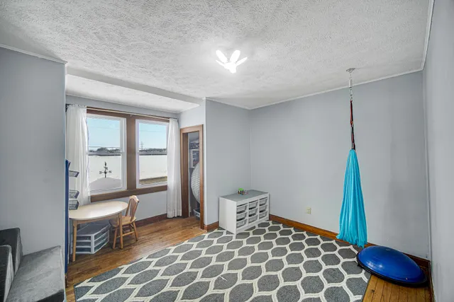 a bedroom with a bed and a chair