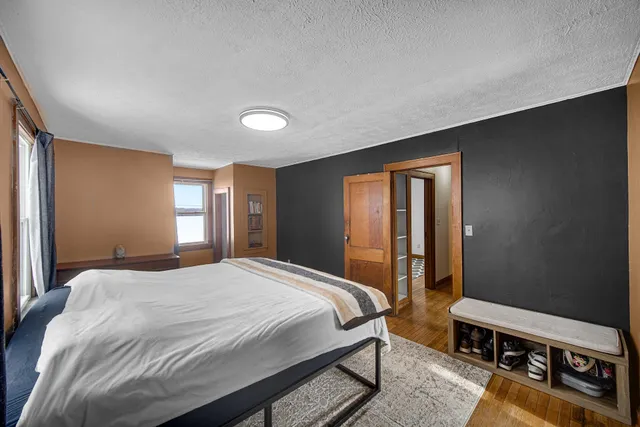 a bedroom with a bed and a window