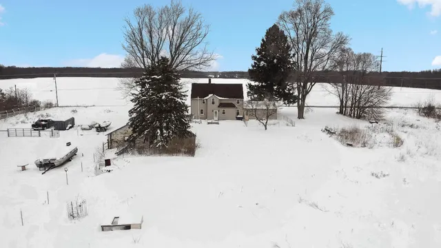 a view of house with snow on the road