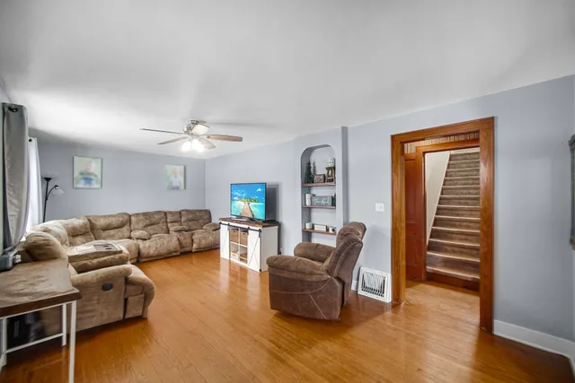 a living room with furniture and a wooden floor