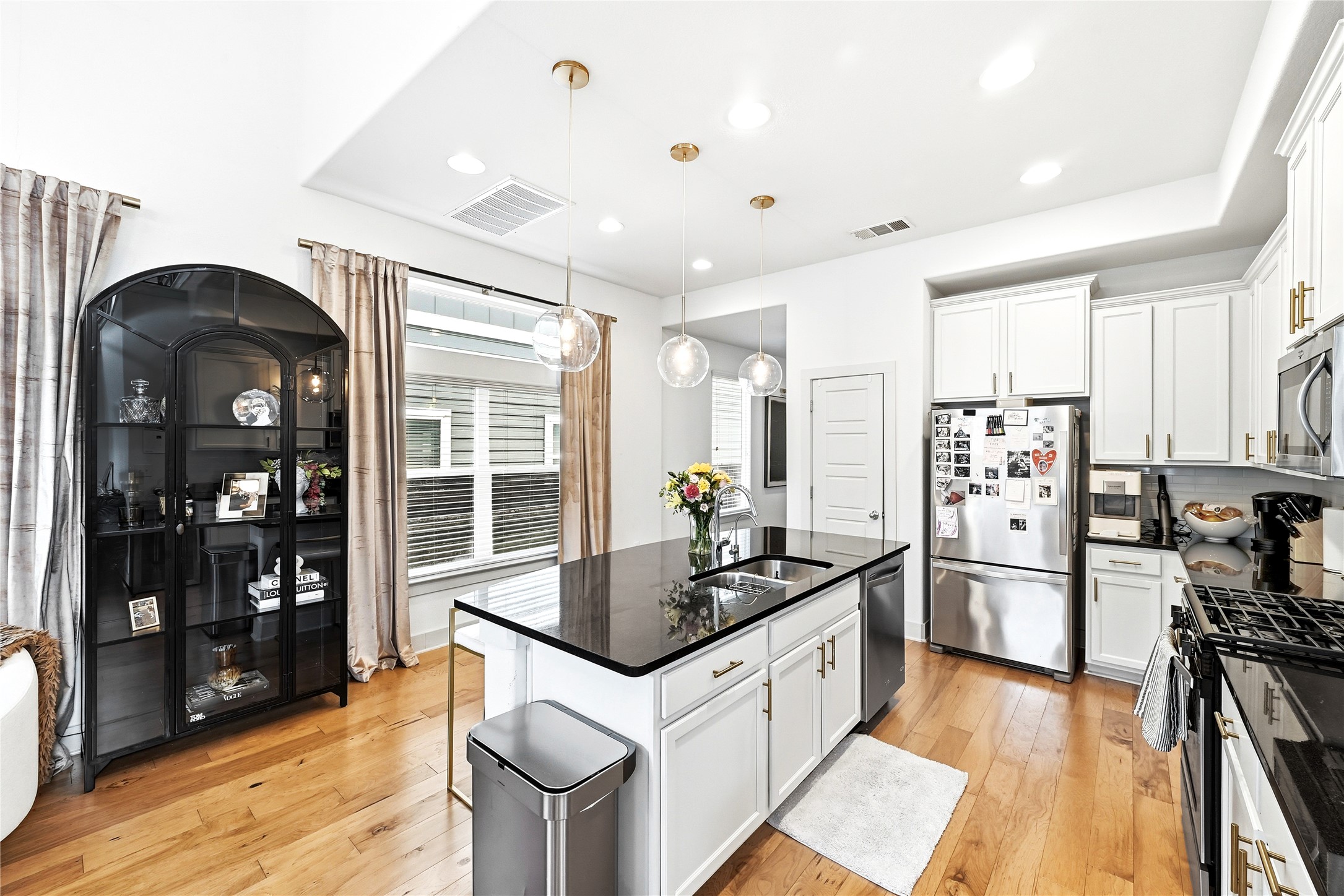 2306 Capulet Street Austin, TX 78741 - Photo 11 of 21 a kitchen with stainless steel appliances kitchen island granite countertop a refrigerator a stove and a wooden floors