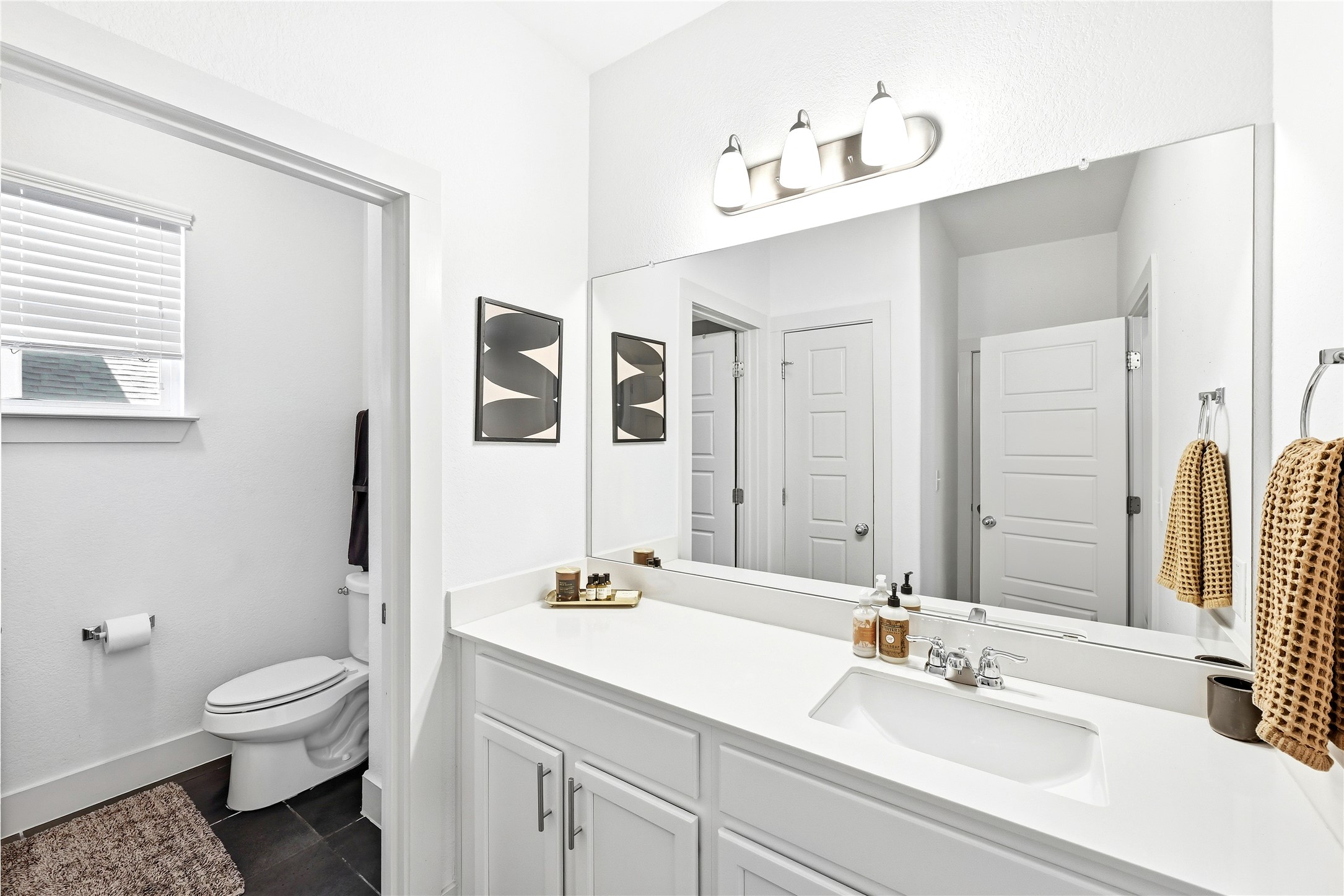 2306 Capulet Street Austin, TX 78741 - Photo 13 of 21 a bathroom with a sink a toilet and mirror