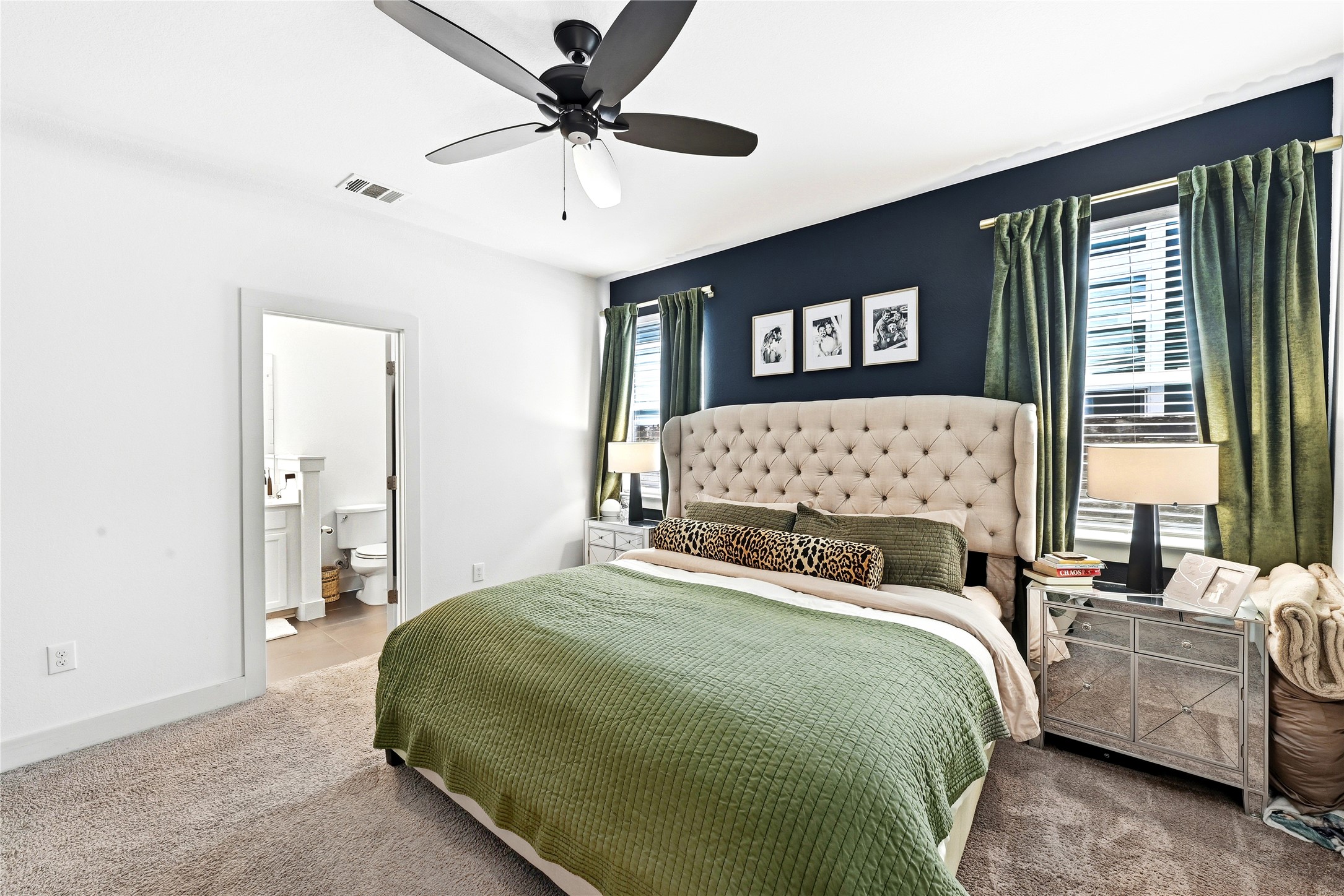 2306 Capulet Street Austin, TX 78741 - Photo 16 of 21 a bed sitting in a bedroom next to a window with a large bed and a chandelier