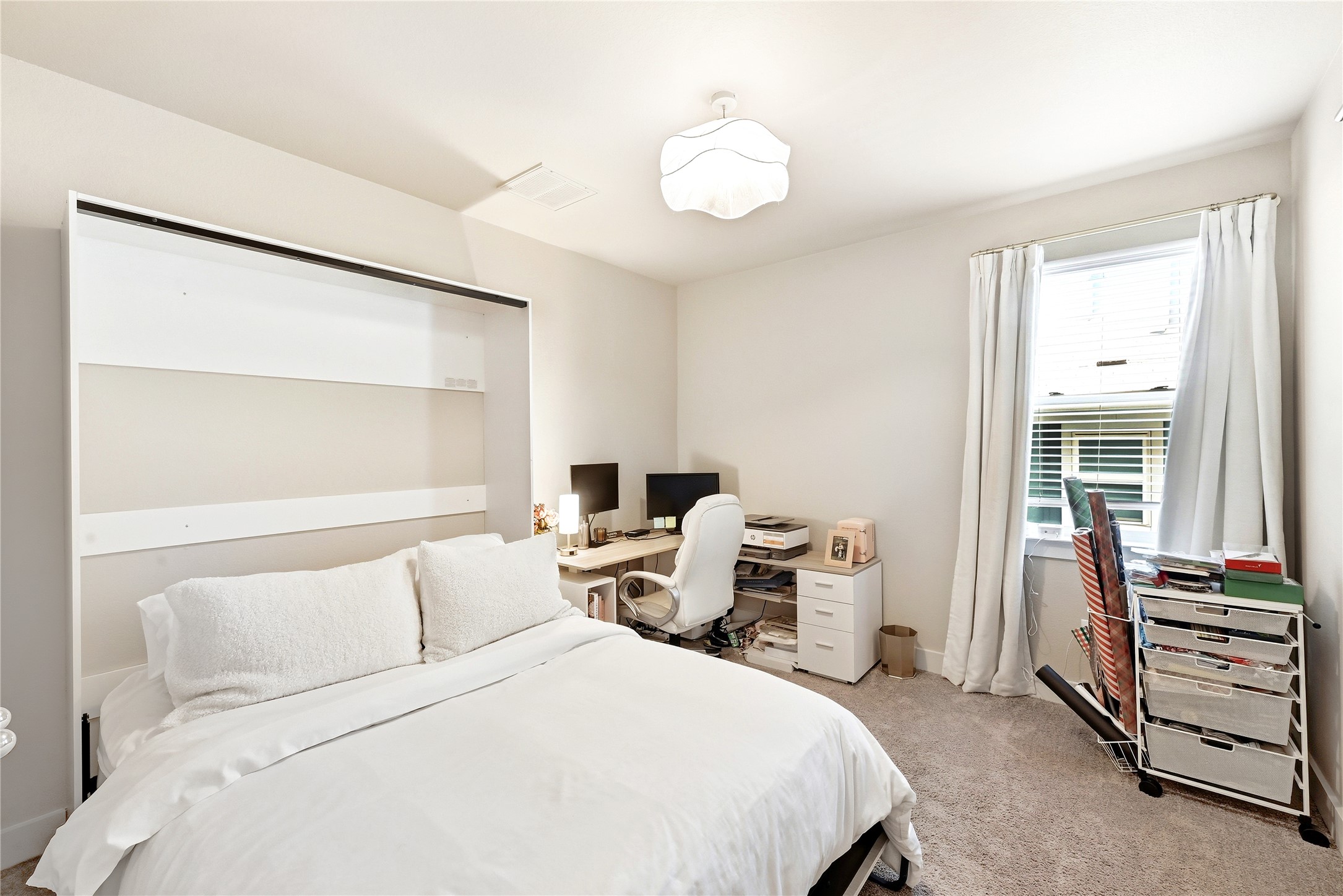 2306 Capulet Street Austin, TX 78741 - Photo 17 of 21 a bedroom with a bed and a large window