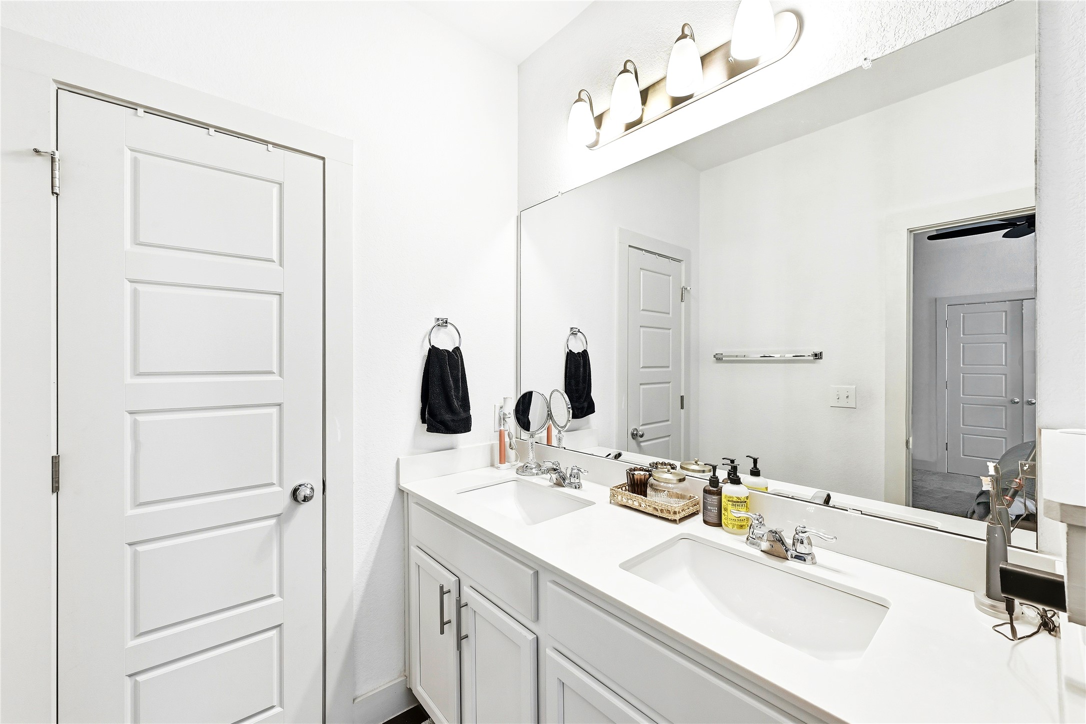 2306 Capulet Street Austin, TX 78741 - Photo 20 of 21 a bathroom with a sink vanity and a mirror
