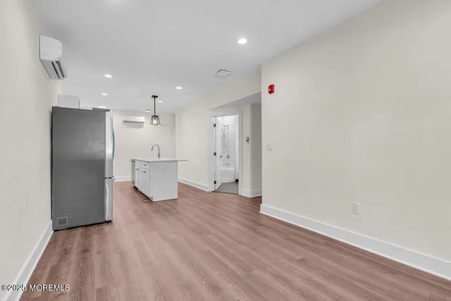 a view of a kitchen with a refrigerator and a sink