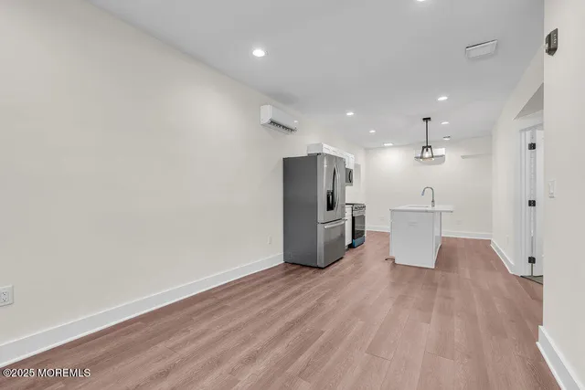 a view of a kitchen with wooden floor