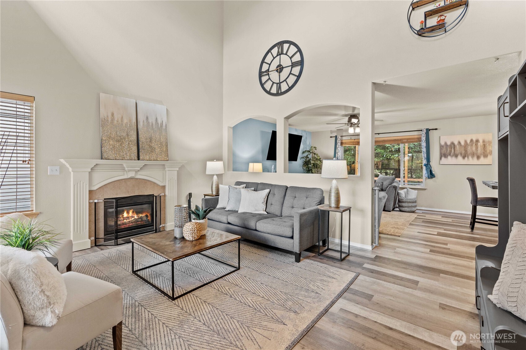 16107 Southeast 255th Place Covington, WA 98042 - Photo 2 of 30 a living room with furniture a clock and a fireplace