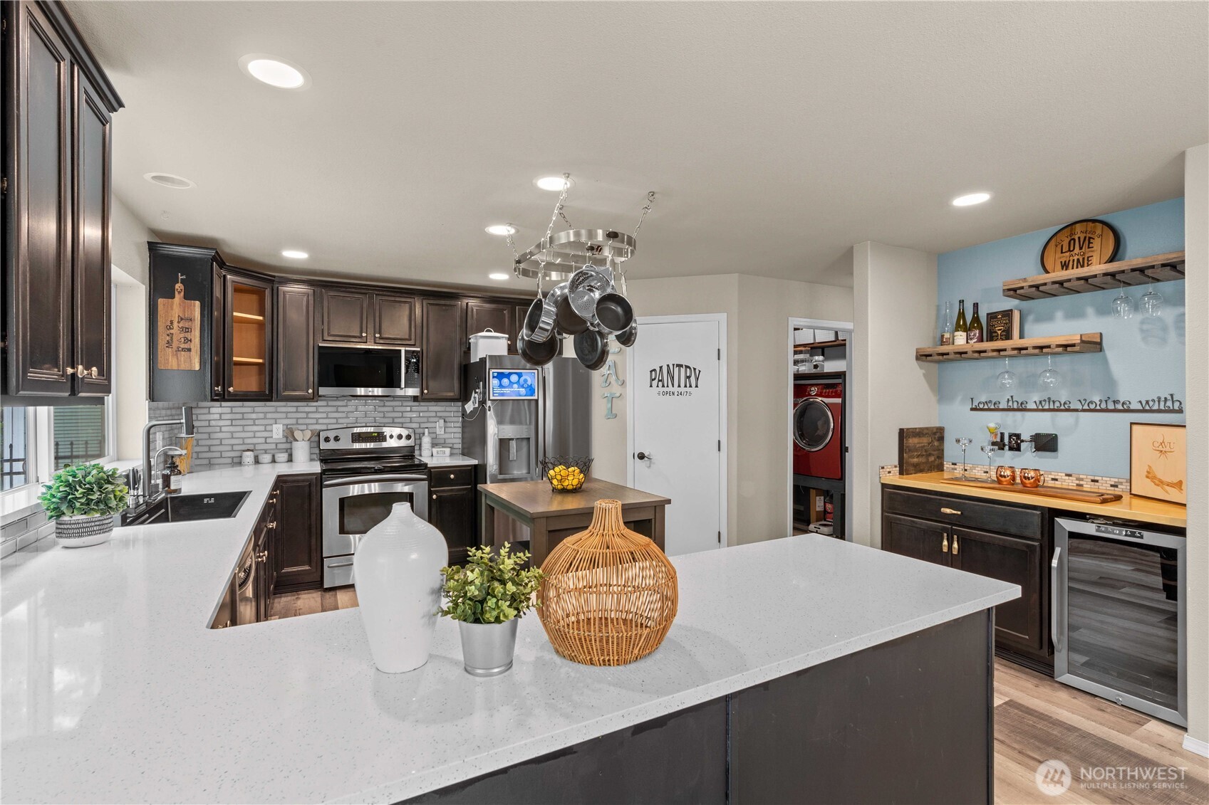 16107 Southeast 255th Place Covington, WA 98042 - Photo 9 of 30 a kitchen with stainless steel appliances granite countertop a sink dishwasher stove top oven and cabinets with wooden floor