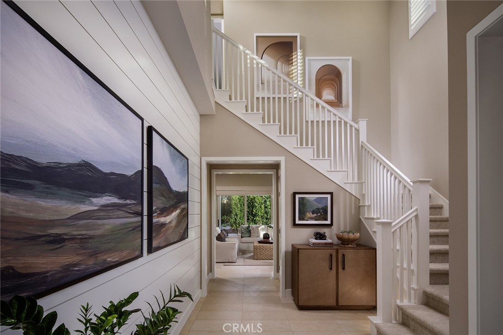 105 EVERSEDGE Irvine, CA 92618 - Photo 3 of 8 a view of a livingroom with furniture staircase wooden floor and staircase
