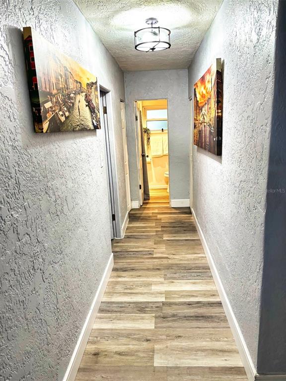 40 East Princeton Street Orlando, FL 32804 - Photo 12 of 14 a view of a hallway with wooden floor and windows