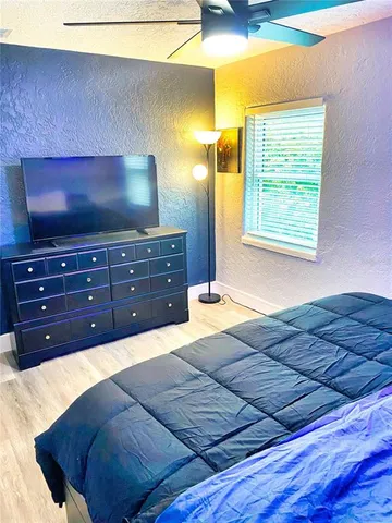 a bedroom with a bed and a flat screen tv