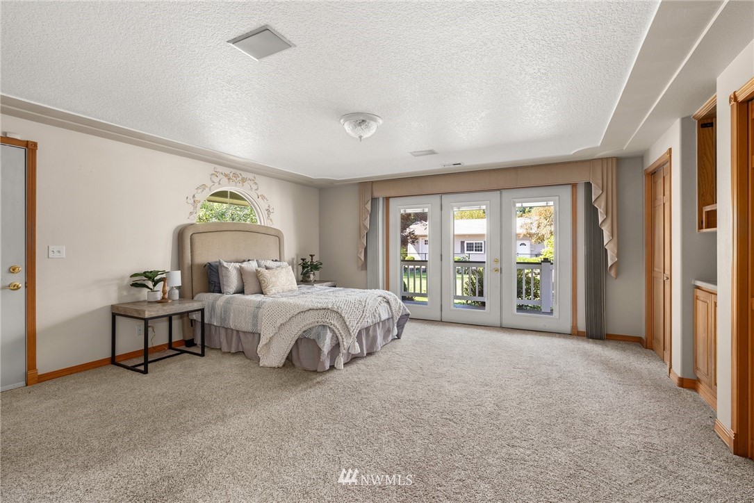 18741 Nutmeg Street Southwest Rochester, WA 98579 - Photo 11 of 39 a spacious bedroom with a bed and a large window