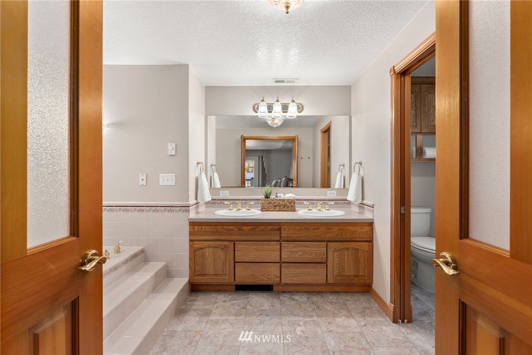 18741 Nutmeg Street Southwest Rochester, WA 98579 - Photo 12 of 39 a bathroom with a tub sink and mirror