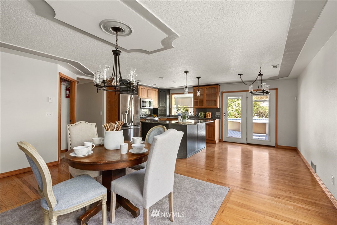 18741 Nutmeg Street Southwest Rochester, WA 98579 - Photo 19 of 39 a dining room with furniture a chandelier and wooden floor