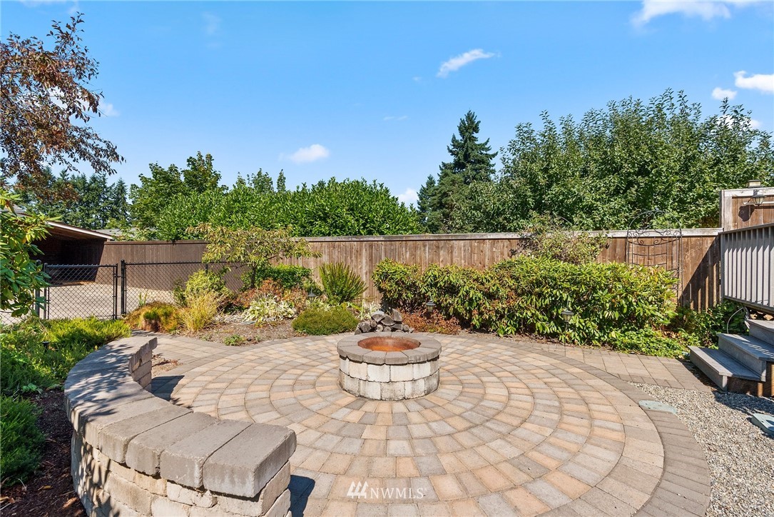 18741 Nutmeg Street Southwest Rochester, WA 98579 - Photo 28 of 39 a view of a backyard with plants and a patio