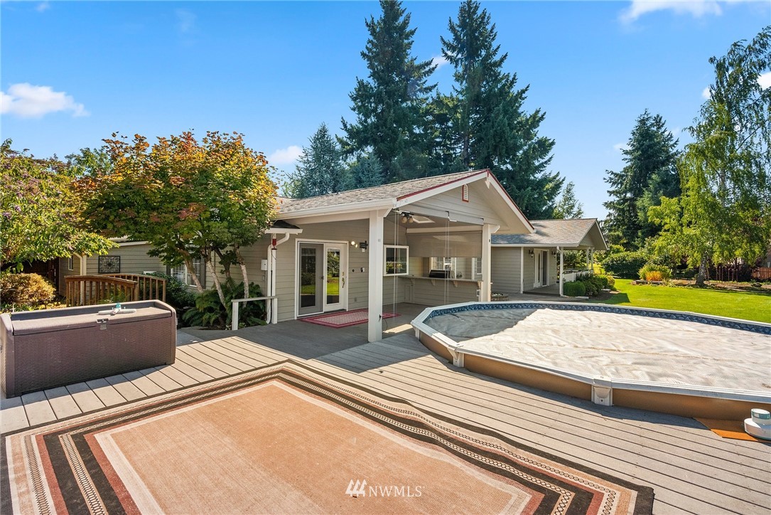 18741 Nutmeg Street Southwest Rochester, WA 98579 - Photo 29 of 39 a view of a house with pool and chairs
