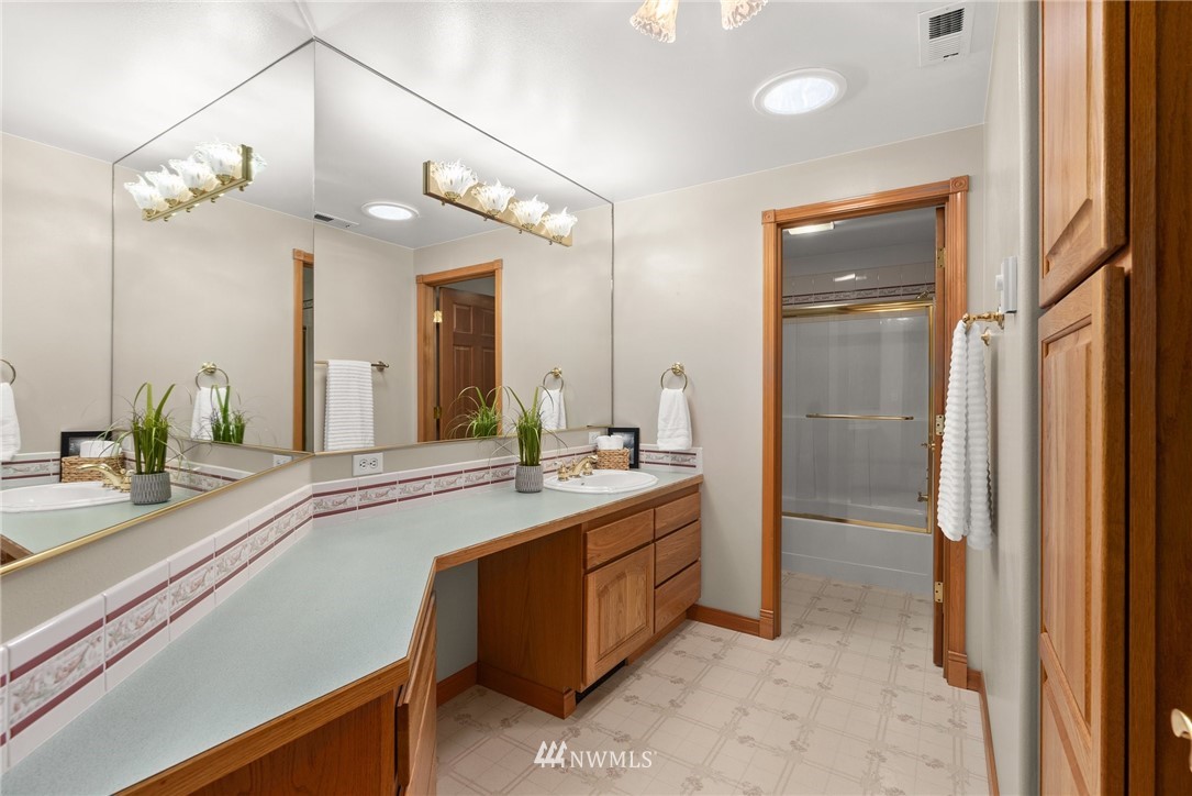 18741 Nutmeg Street Southwest Rochester, WA 98579 - Photo 6 of 39 a spacious bathroom with a granite countertop sink a mirror and a shower