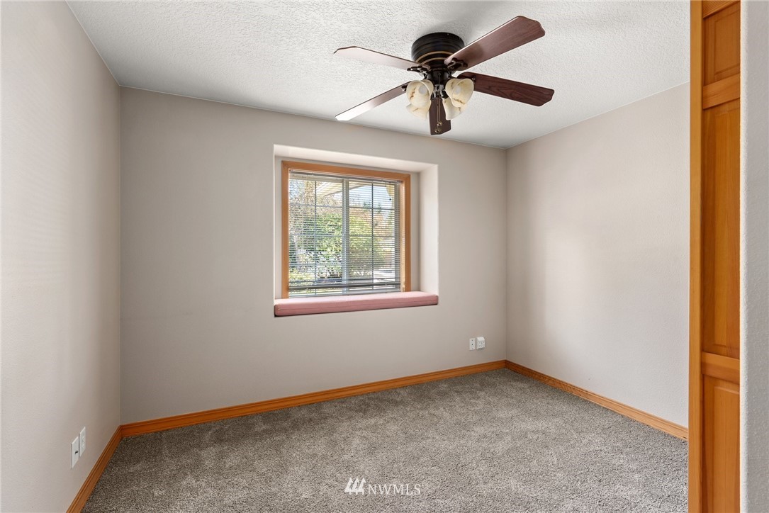 18741 Nutmeg Street Southwest Rochester, WA 98579 - Photo 10 of 39 an empty room with a window and a ceiling fan