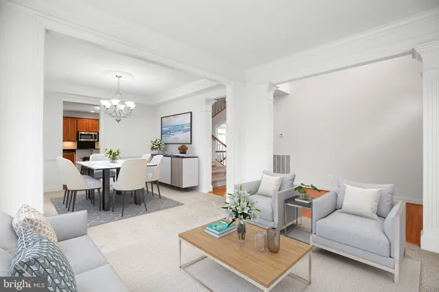 a living room with furniture and view of kitchen