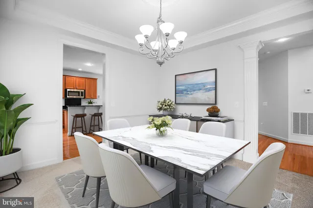 a view of a dining room with furniture wooden floor and a chandelier
