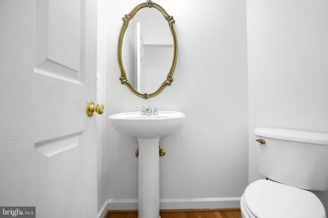 a bathroom with a sink a mirror and a toilet
