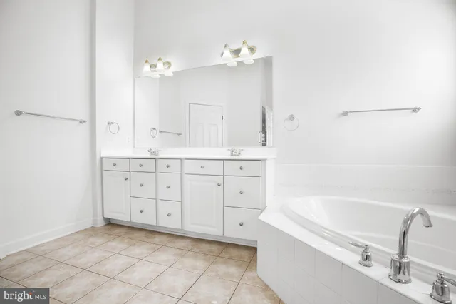 a bathroom with a tub sink and a mirror