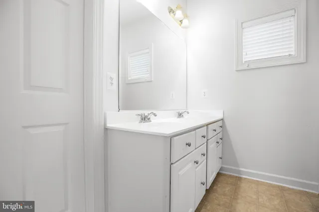 a bathroom with a double vanity sink and mirror