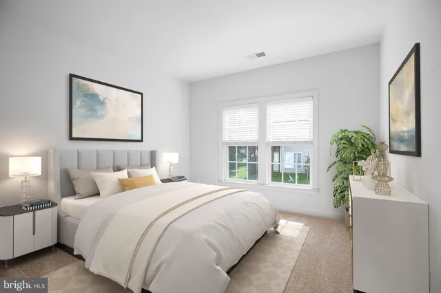 a bedroom with bed and a large window