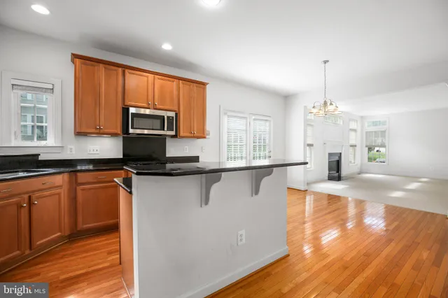 a kitchen with stainless steel appliances granite countertop a sink a stove top oven a counter space and cabinets