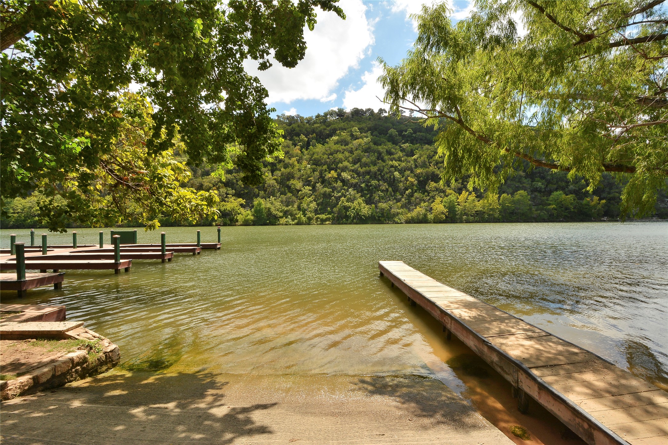 3513 Grimes Ranch Road Austin, TX 78732 - Photo 26 of 32 Dock area featuring a boat ramp, a water view, and a forest view