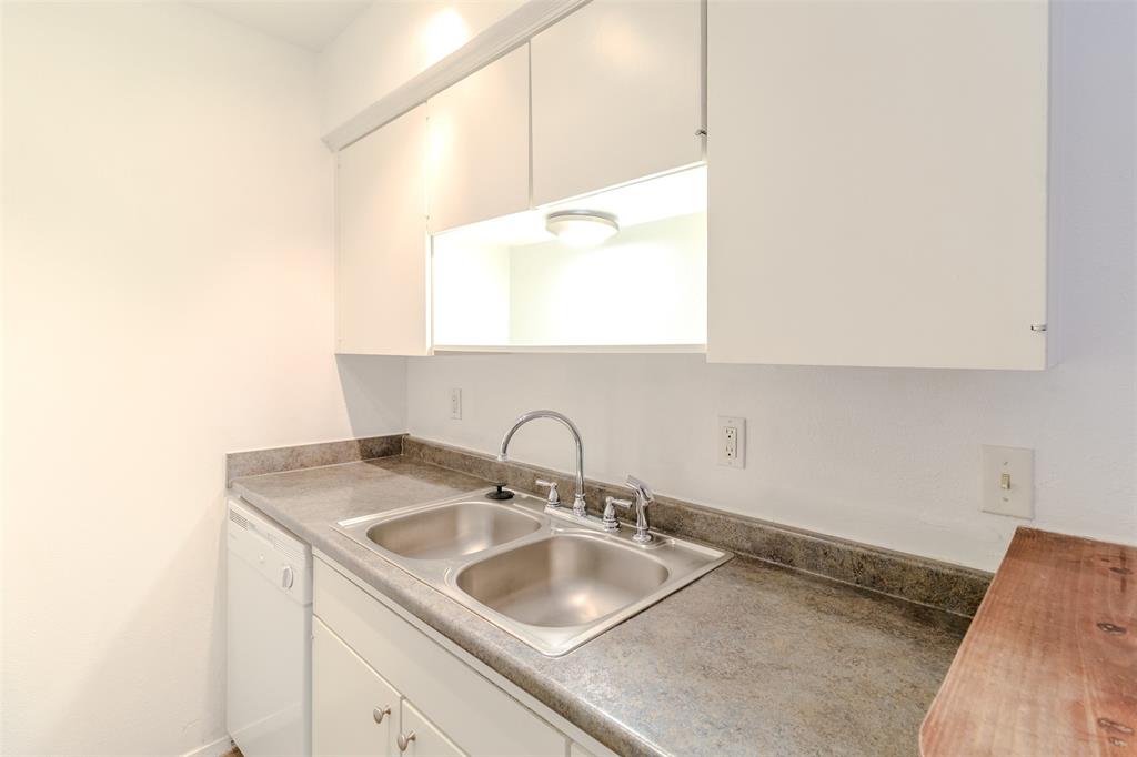 4859 Cedar Springs Road, Unit 234 Dallas, TX 75219 - Photo 24 of 30 a bathroom with a sink and a mirror