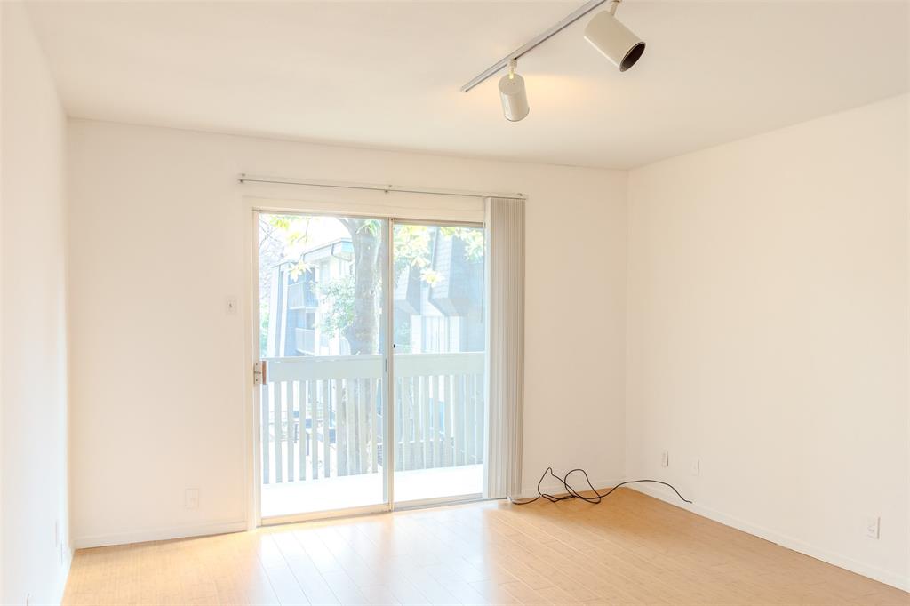 4859 Cedar Springs Road, Unit 234 Dallas, TX 75219 - Photo 6 of 30 a view of an empty room with a window