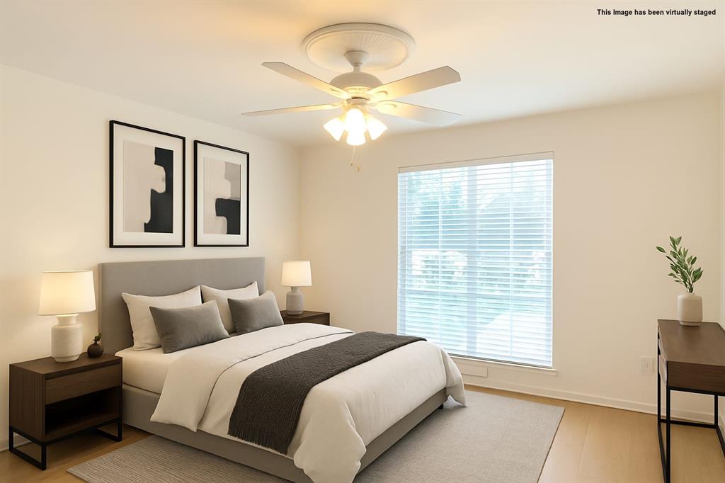4859 Cedar Springs Road, Unit 234 Dallas, TX 75219 - Photo 10 of 30 a spacious bedroom with a bed and a chandelier